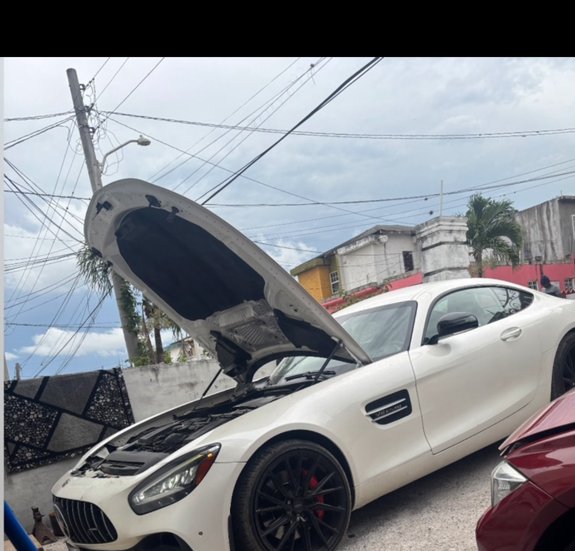 A Mercedes-AMG GT with the bonnet up at JRC Automotive, Ocho Rios