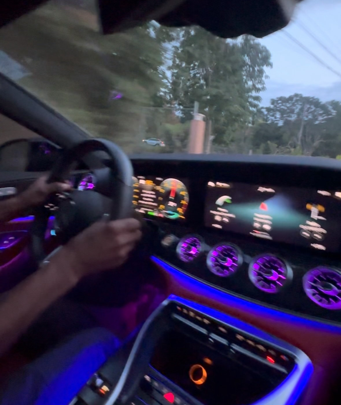 Mercedes-AMG interior with the climate and infotainment displays lit